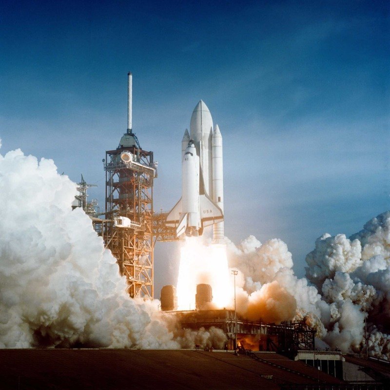 Space Shuttle lifting off from the launch pad